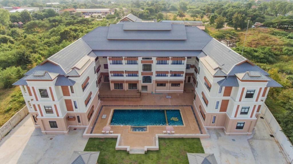 an aerial view of a building with a swimming pool at S-Tawan Hotel & Convention in Maha Sarakham