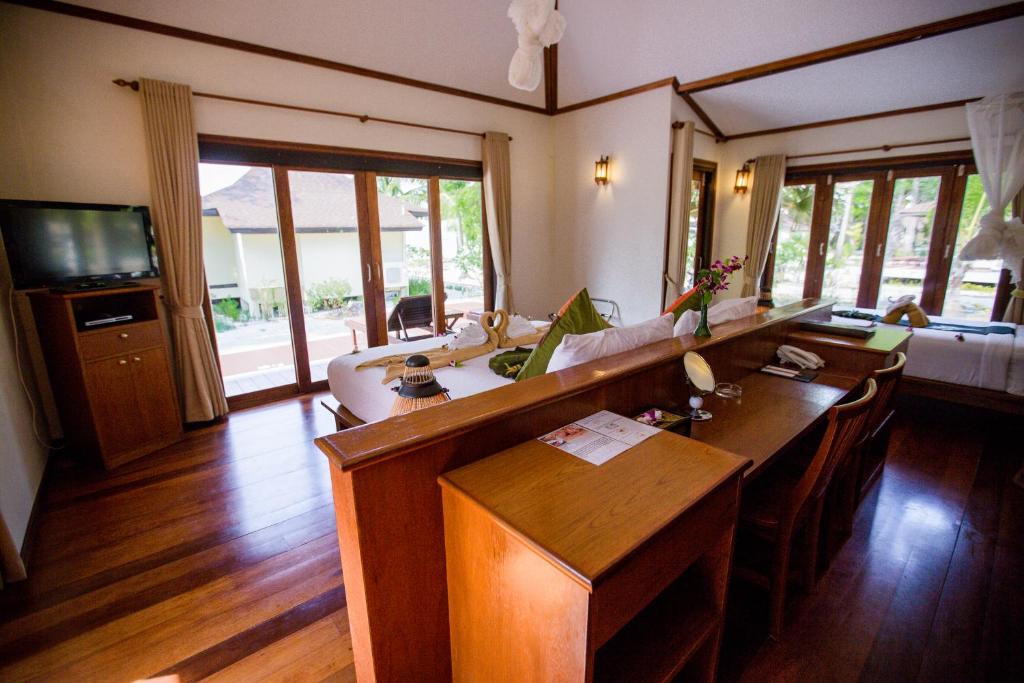 a living room with a couch and a table at Koh Mook Sivalai Beach Resort in Ko Mook