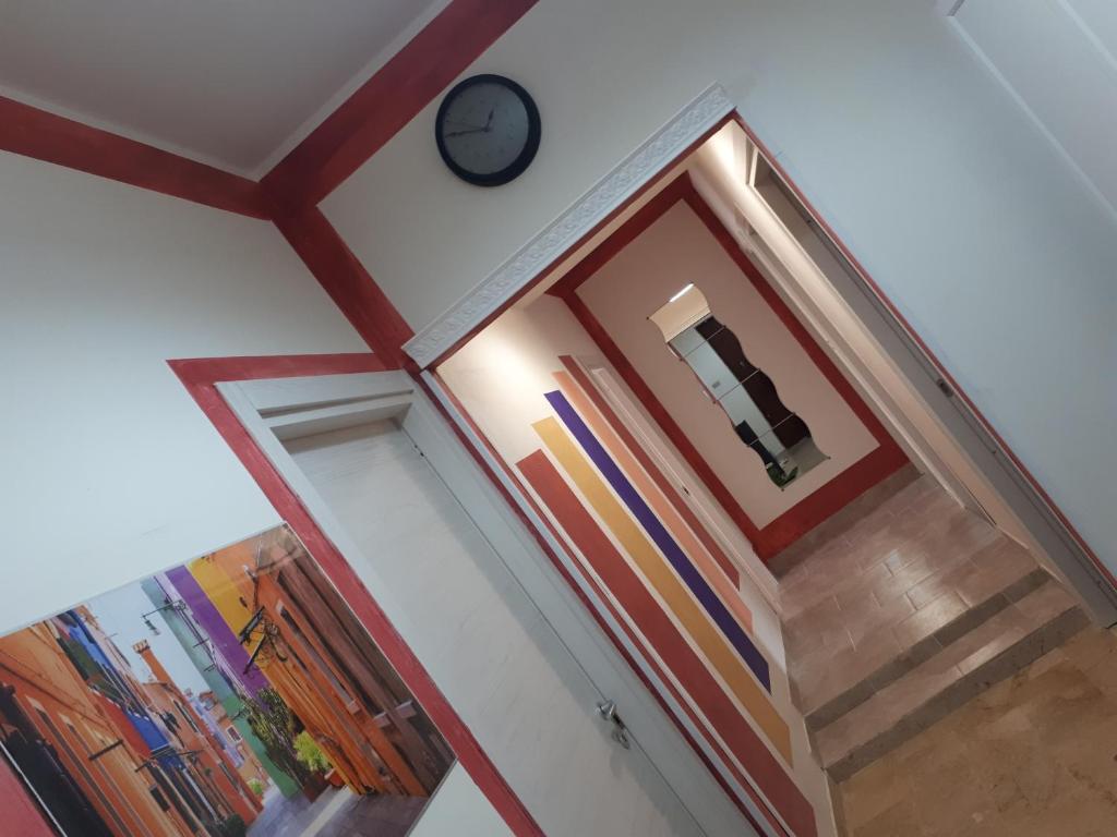 a hallway with a clock on the wall at B&B RELAX in Messina