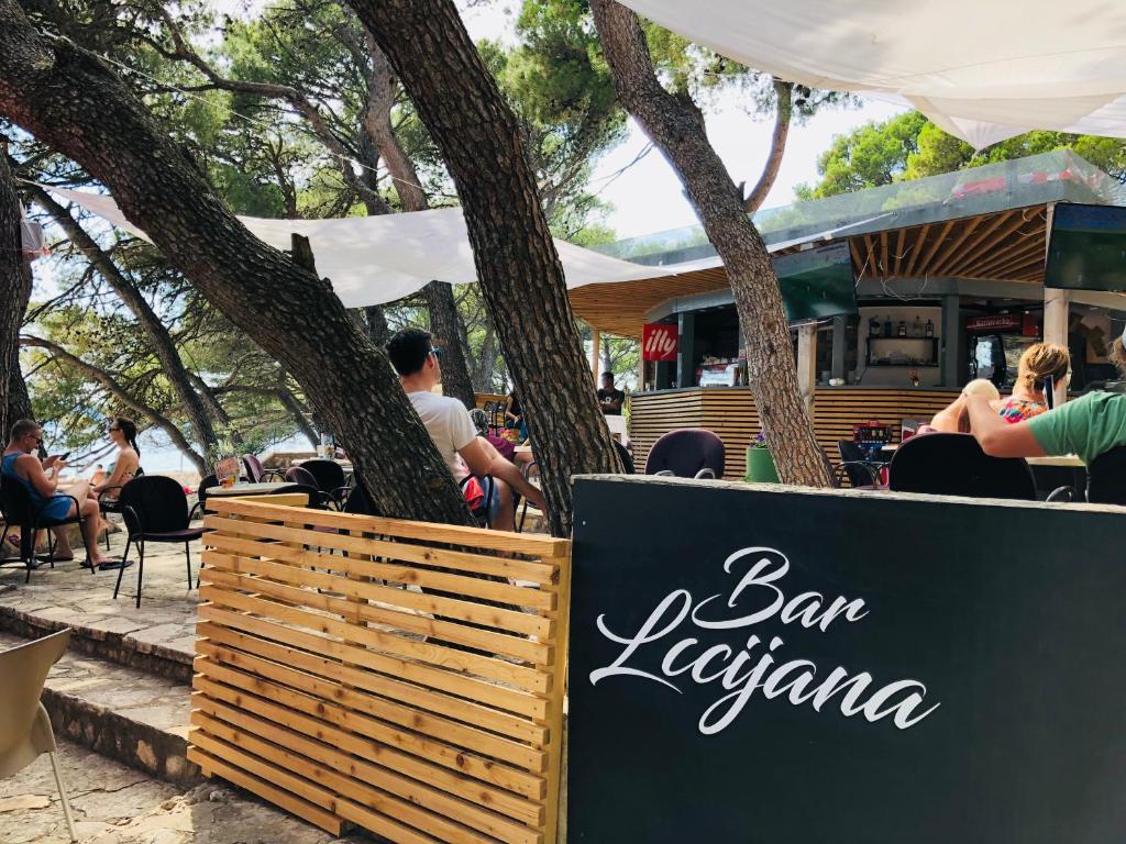a sign in front of a bar kaciaina restaurant at Camping Kozarica Mobile Homes in Pakoštane