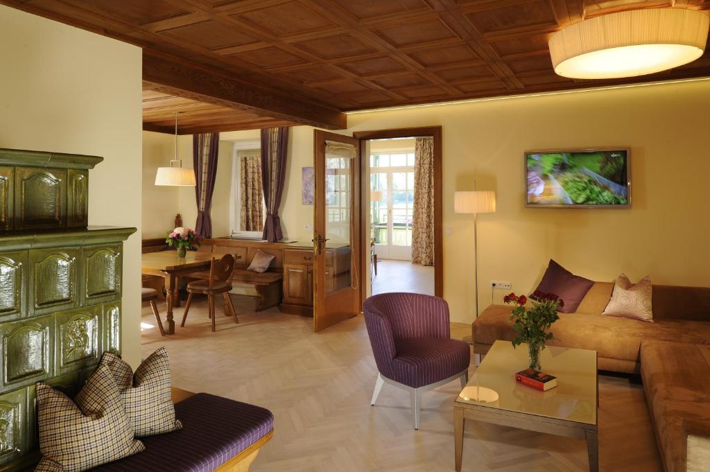 a living room with a couch and a table at Hotel & Gasthof Fürberg in Sankt Gilgen