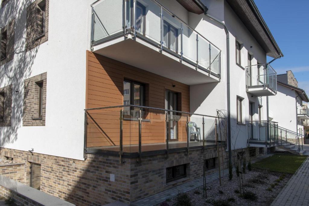a house with a balcony on the side of it at Apartamenty Ewa II in Ustka