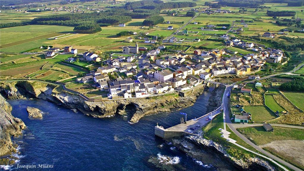 an aerial view of a small town next to the water at O Lar de Carmiña in Devesa