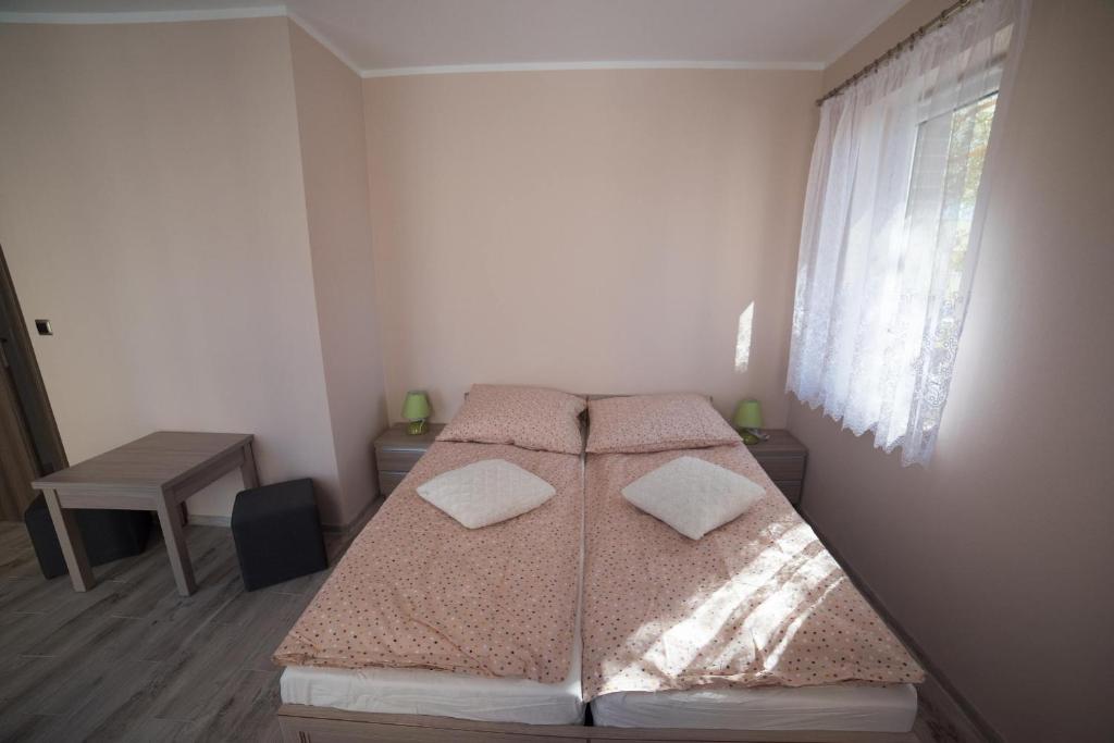 Postel nebo postele na pokoji v ubytování Apartamenty Ewa II