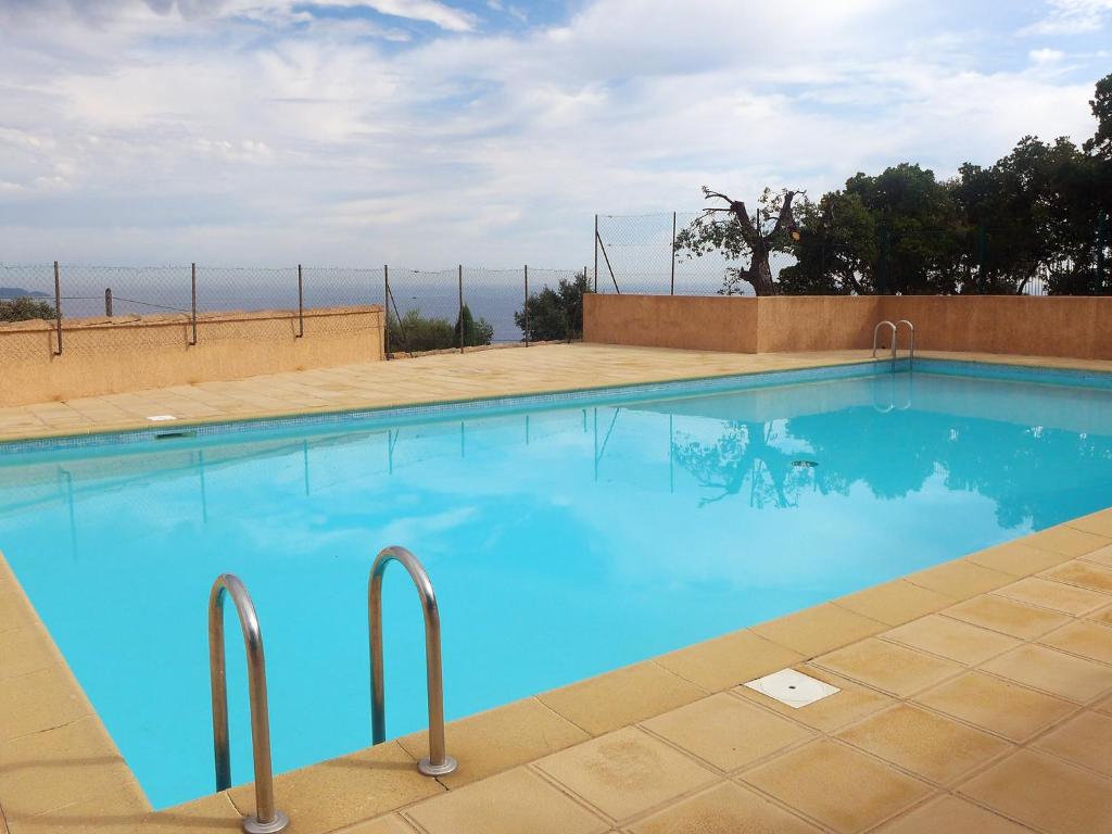 a large swimming pool with blue water at Apartment Les Jardins d'Azur by Interhome in Cavalaire-sur-Mer