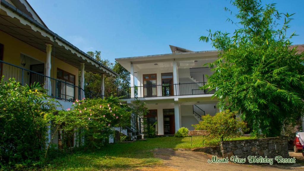 an image of a house with trees in the foreground at Mount View Holiday Resort in Dambulla