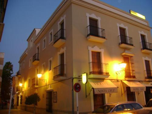 a building with a car parked in front of it at Santa Cruz in Los Palacios y Villafranca