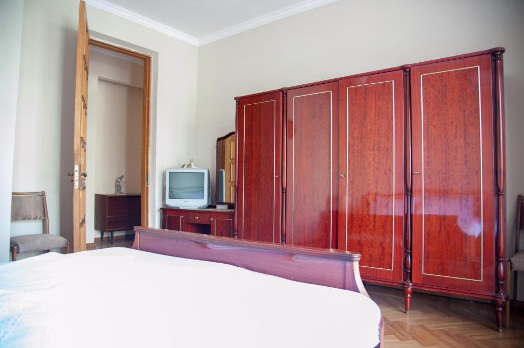 a bedroom with a bed and a tv in it at Cozy Guest House in Old Batumi in Batumi