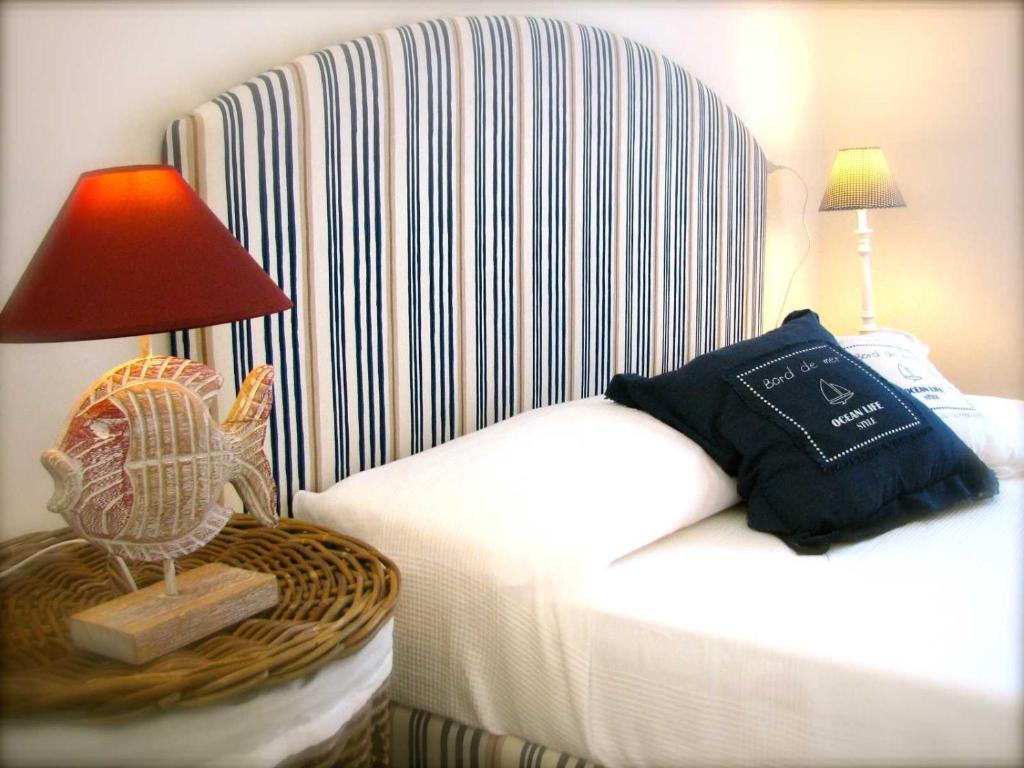 a hotel room with a bed with a lamp and a chair at Stellamare in Caorle