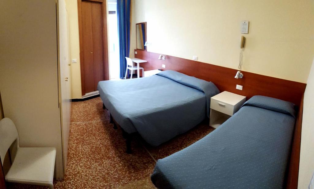 Un ou plusieurs lits dans un hébergement de l'établissement Hotel Guya