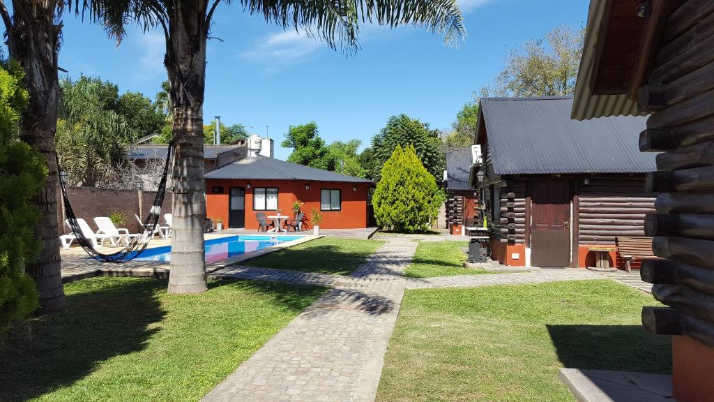 a house with a swimming pool in a yard at Quechua Cabañas Funes in Funes