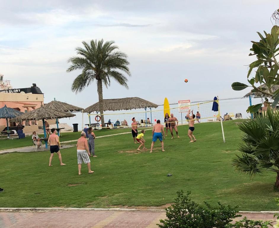 a group of people playing a game of volleyball on the beach at Flamingo Beach Hotel in Umm Al Quwain