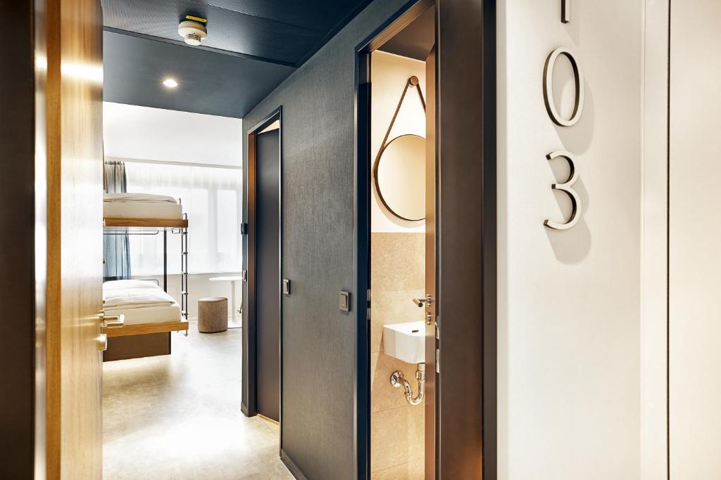 a hallway with a door leading to a bedroom at H2 Hotel München Olympiapark in Munich