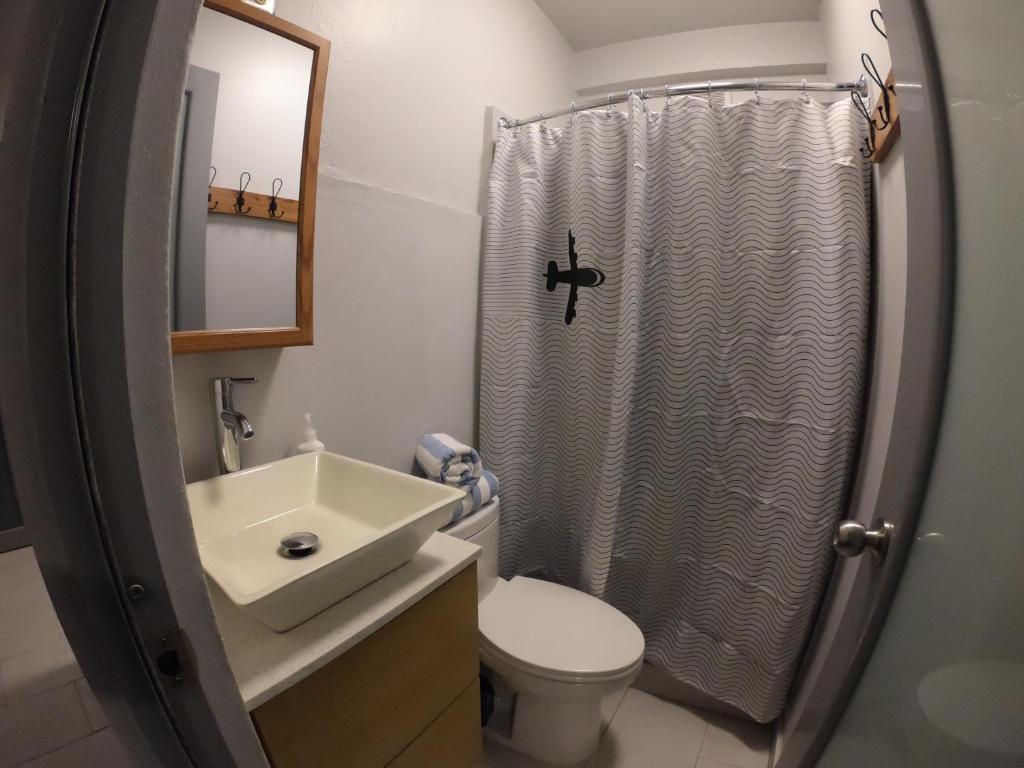 a bathroom with a shower and a toilet and a sink at 1802 at San Juan in San Juan