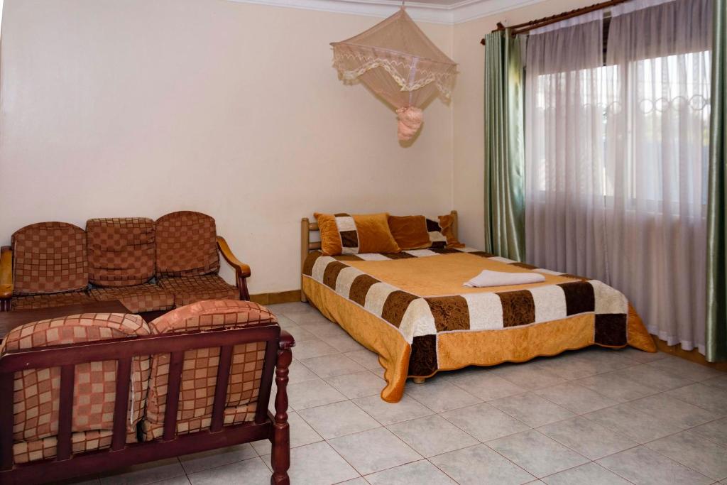 Postel nebo postele na pokoji v ubytování Hotel Millenium Kampala Zaana