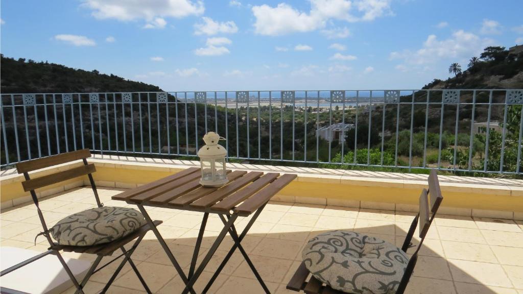 a table and chairs on a balcony with a view at ARTSEA Studio Apartment with sea view in ‘En Hod