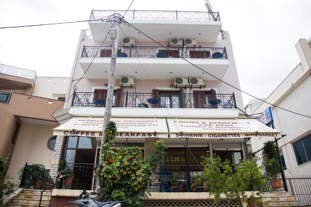 a tall white building with balconies on it at Holiday Zigos in Igoumenitsa