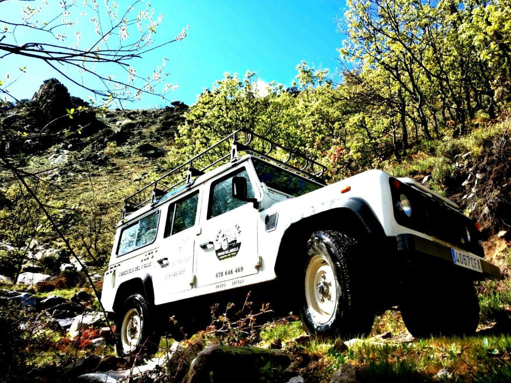 a white jeep parked on the side of a hill at Prado del abuelo in Cabezuela del Valle