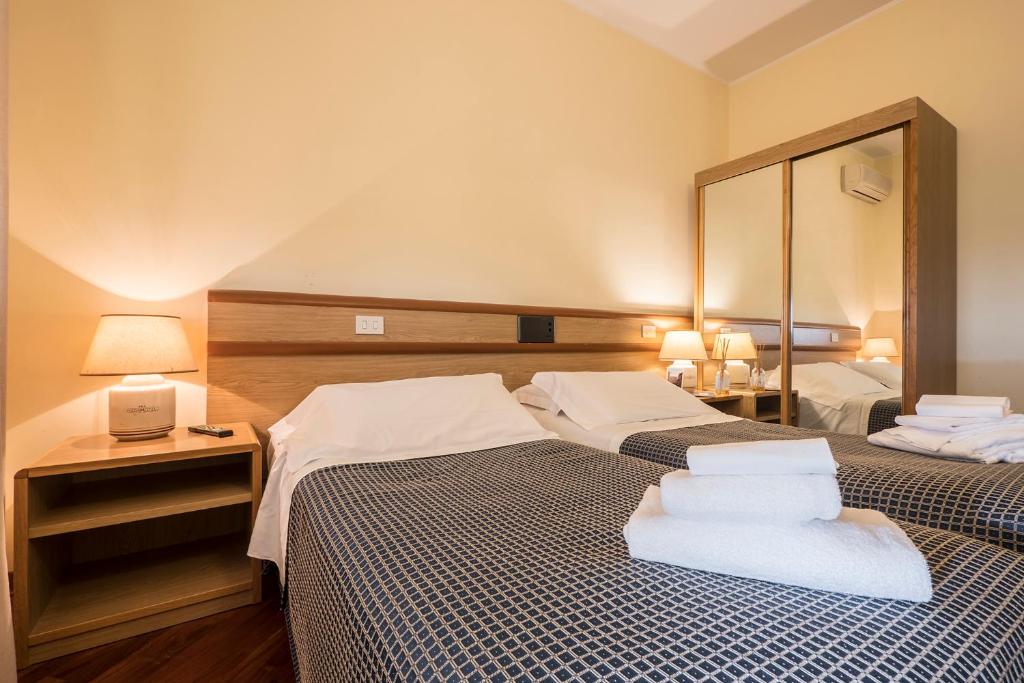 Postel nebo postele na pokoji v ubytování Hotel Vega Perugia