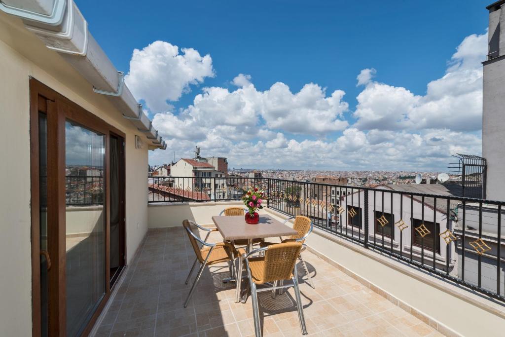 a balcony with a table and chairs and a view at Taxim Hotel Marin in Istanbul