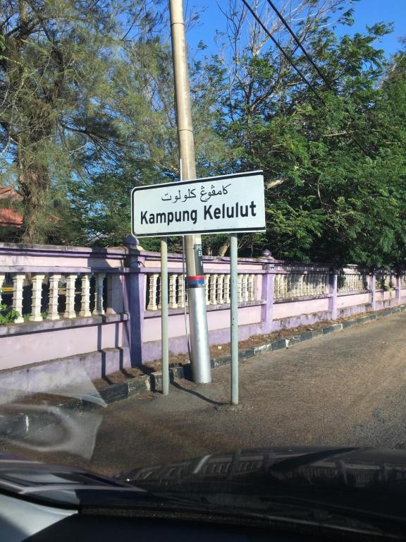 a street sign on the side of a road at Zara Homestay in Marang