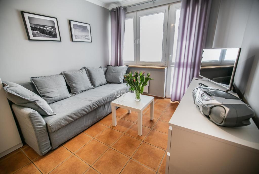 a living room with a couch and a table at Apartament w Centrum in Ustka