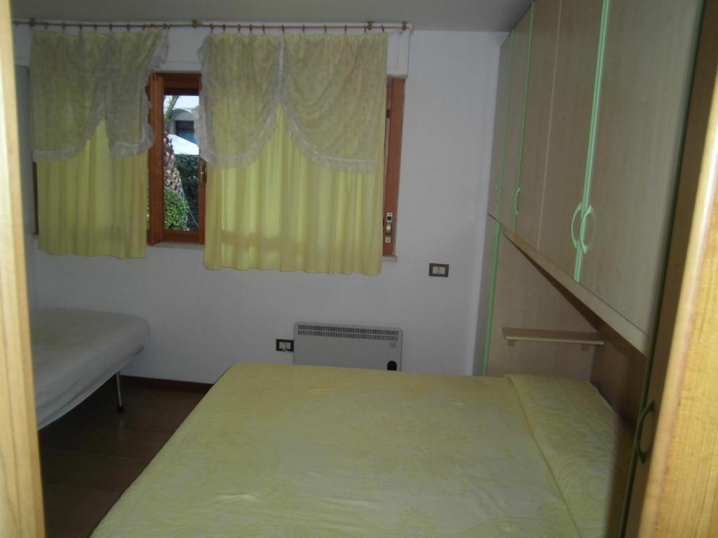 a small bedroom with a bed and a window at due passi dal mare in San Benedetto del Tronto