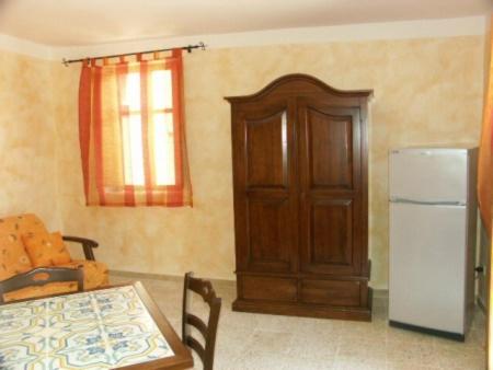 kuchnia ze stołem i lodówką w pokoju w obiekcie Casa Di Nonna Pina w mieście Marina di Camerota