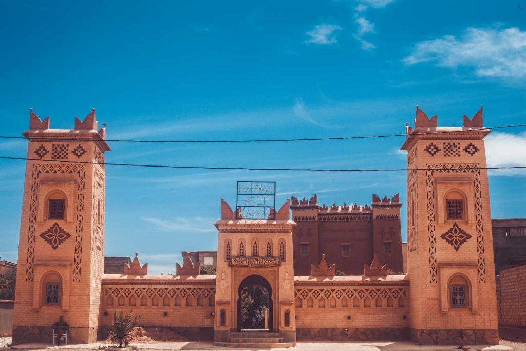 a large building with two towers on top of it at Kasbah Ait Kassi in Boumalne