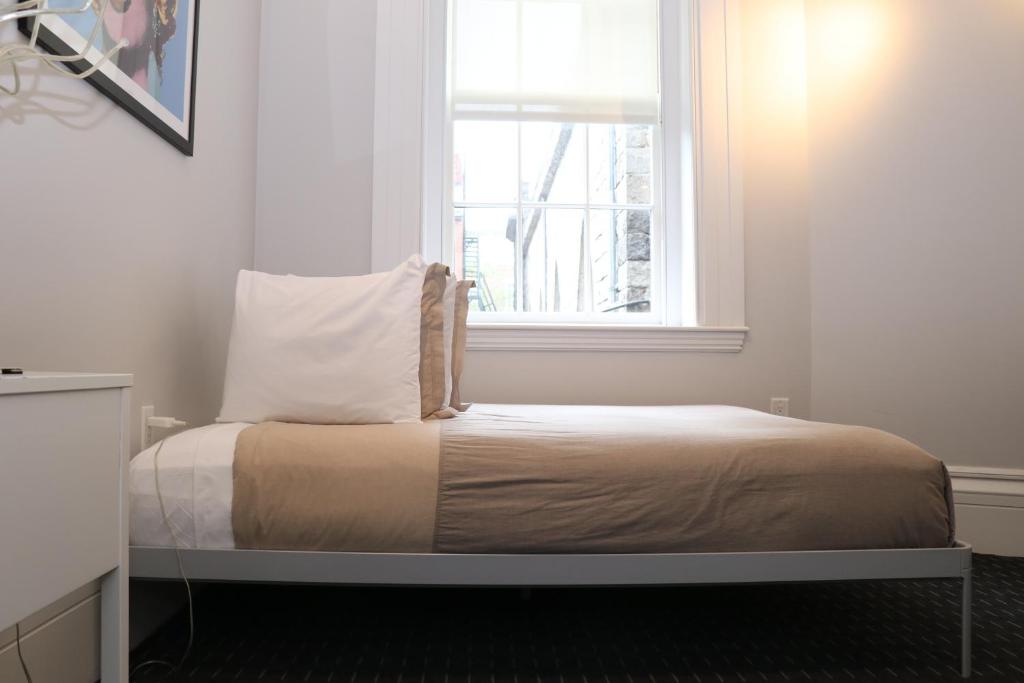 a bed in a room with a window at Charming & Stylish Studio on Beacon Hill #6 in Boston