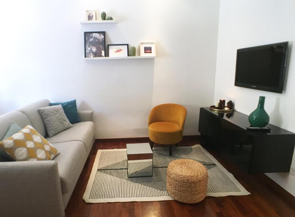 a living room with a couch and a chair at La casa di ringhiera in Milan