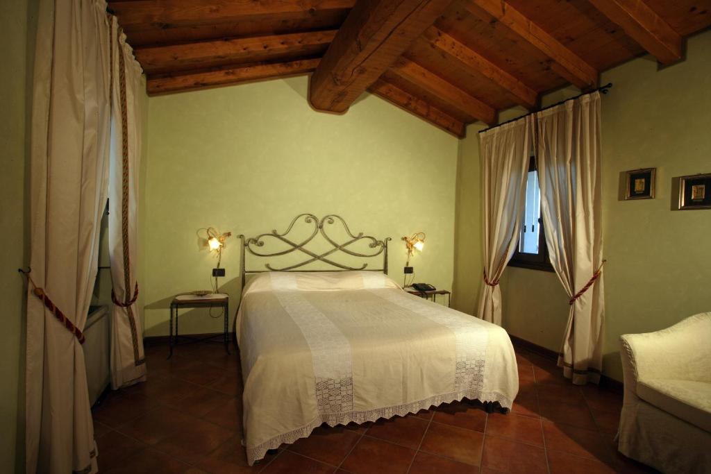 Postel nebo postele na pokoji v ubytování Agriturismo Macesina