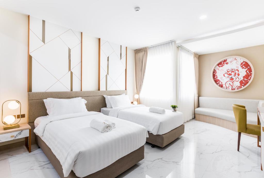 Postel nebo postele na pokoji v ubytování The 8 Hotel Udonthani