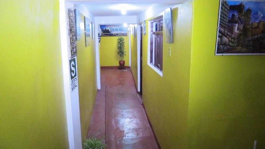 a hallway with green and yellow walls at Dream House B&B in Huaraz