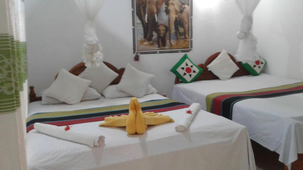 Postel nebo postele na pokoji v ubytování Kalana Homestay