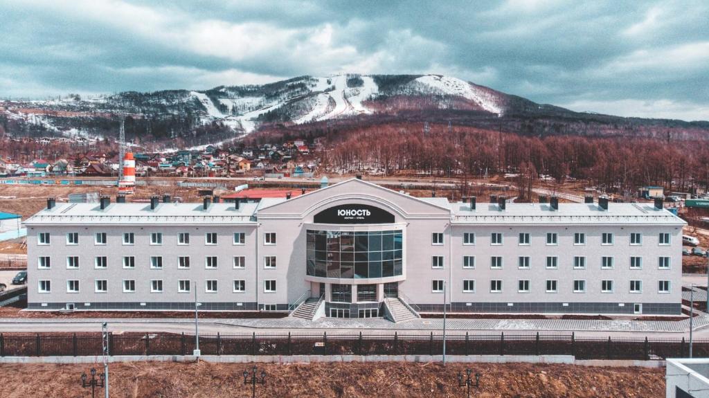 a sony building in front of a snow covered mountain at Отель Юность in Yuzhno-Sakhalinsk