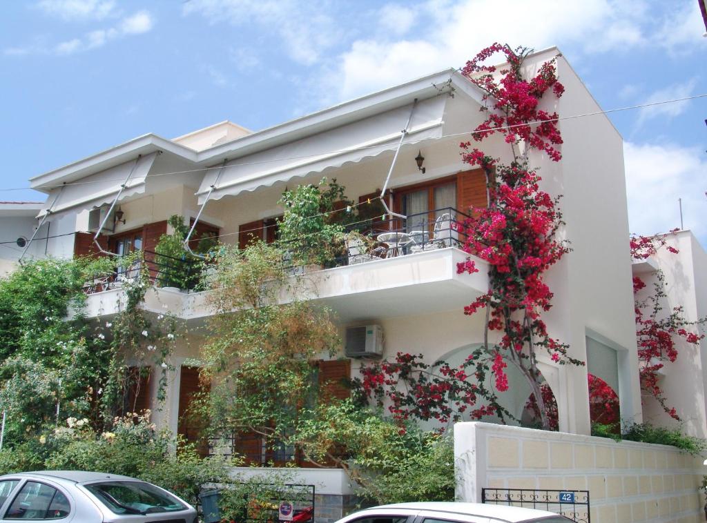 a building with flowers on the side of it at Filoxenia Apartments in Mytilini