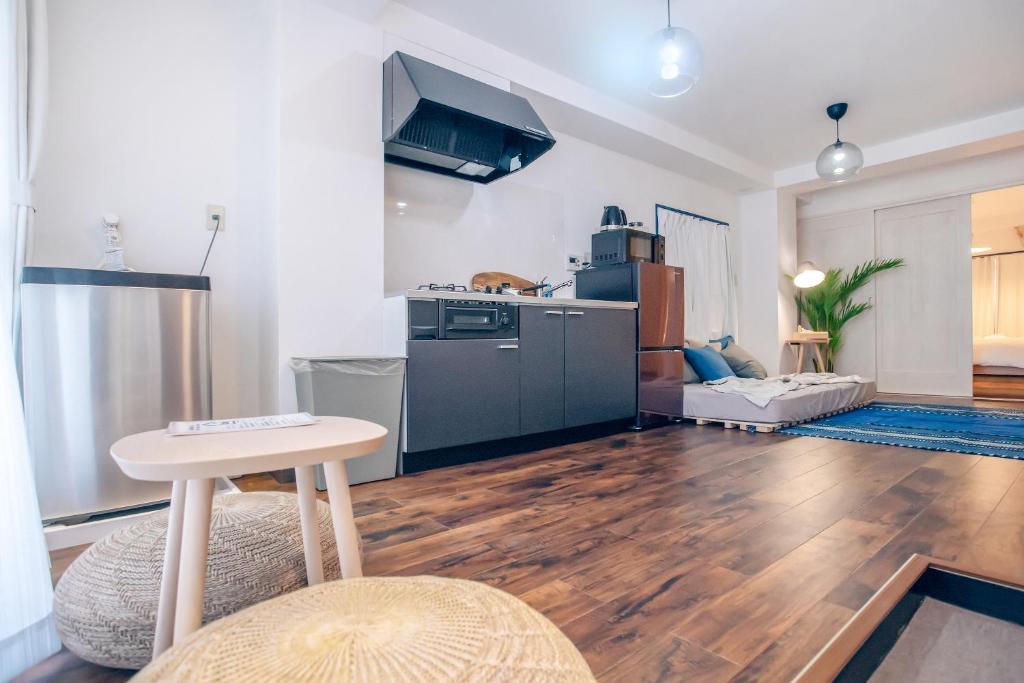 a large living room with a kitchen and a table at Nippori Fabric Hotel in Tokyo