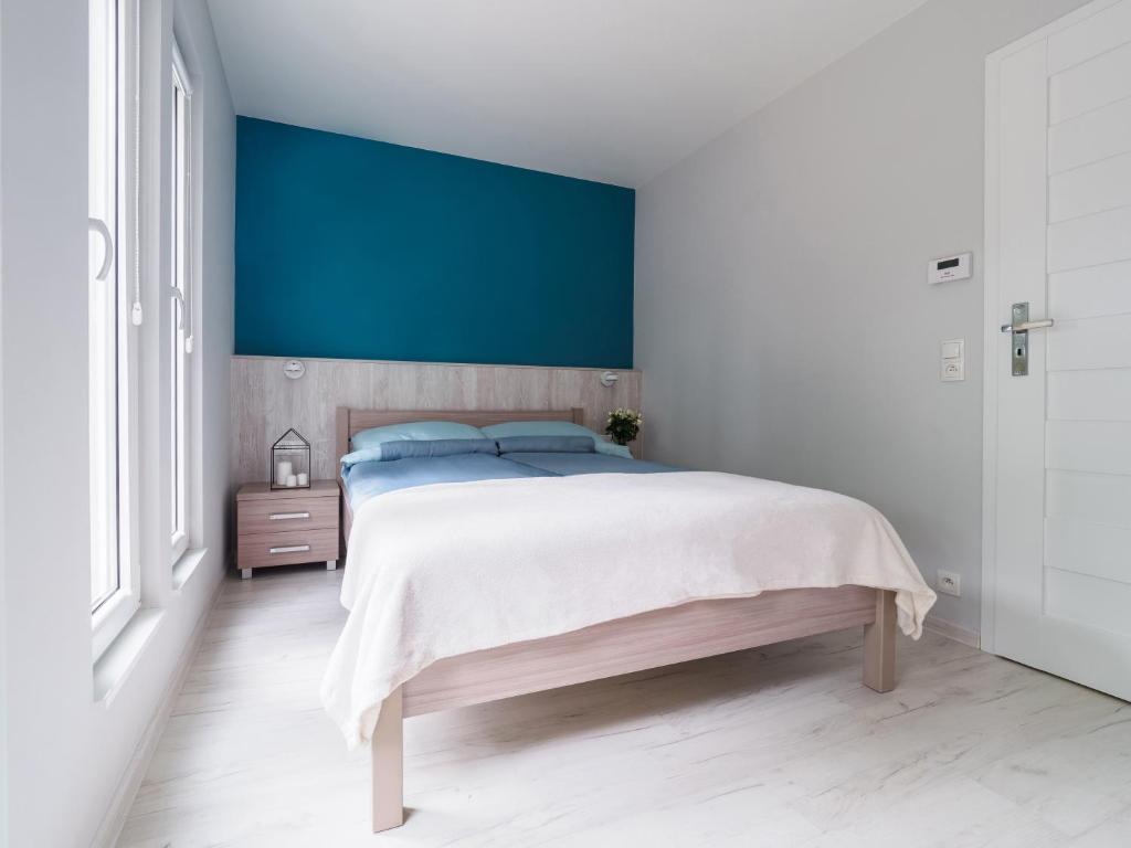 Postel nebo postele na pokoji v ubytování Parkova Apartamenty