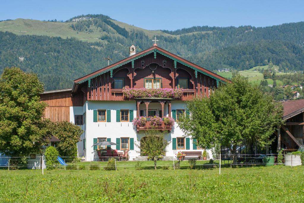 a large house in the middle of a field at Leindlhof in Kössen