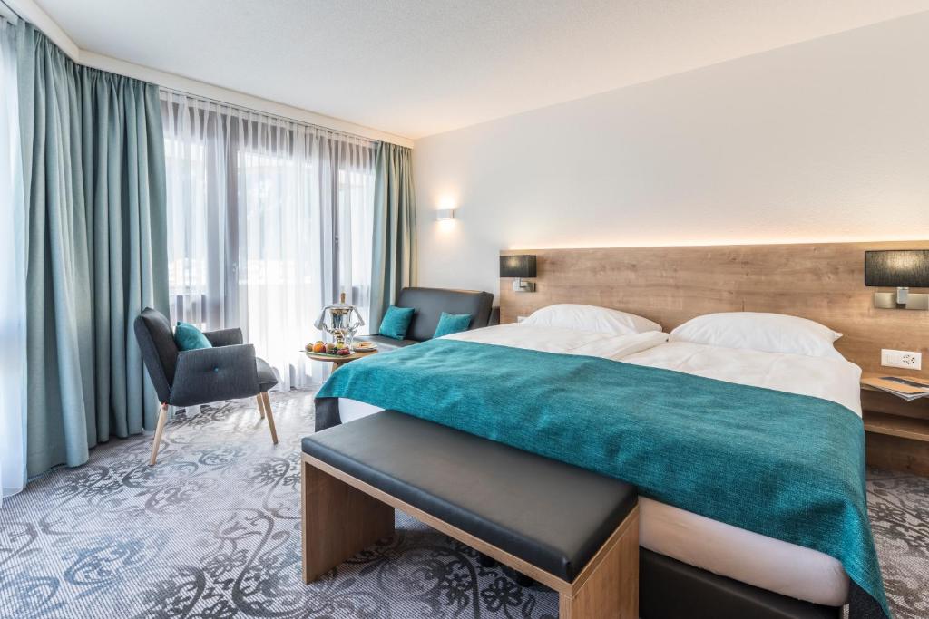 Postel nebo postele na pokoji v ubytování Central Sporthotel Davos