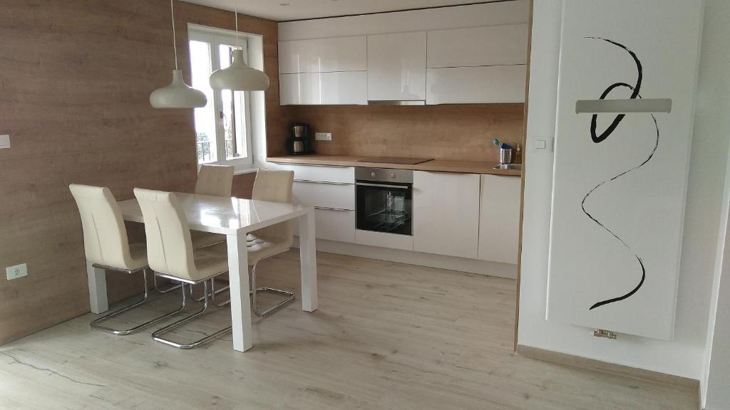 a kitchen with a dining room table and chairs at Apartments Ostanek 2 in Portorož