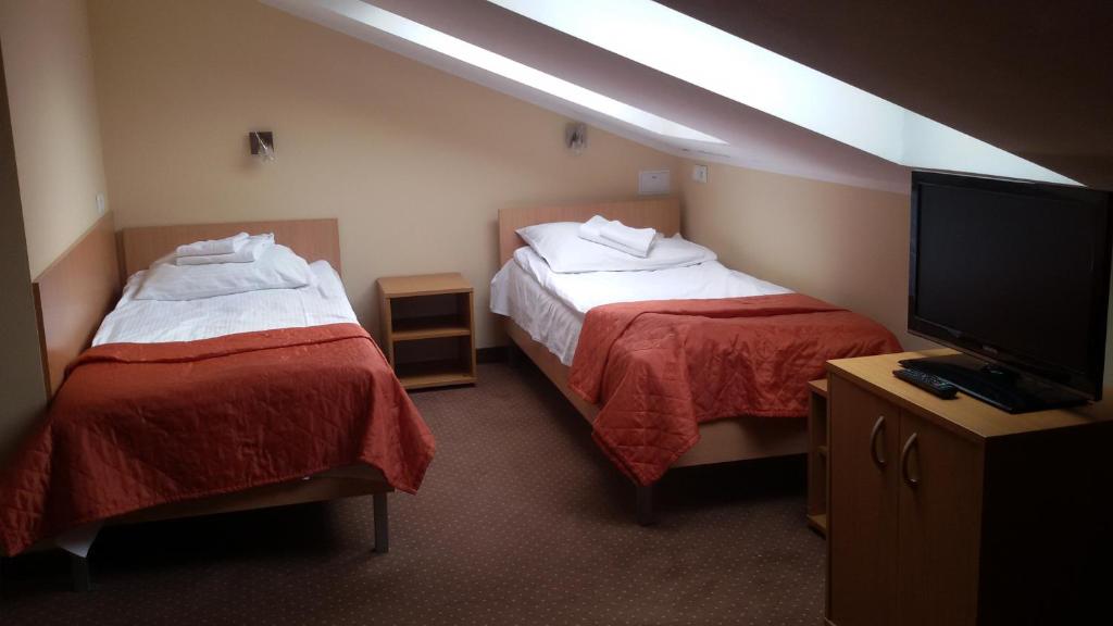 Postel nebo postele na pokoji v ubytování Hotel *** NAT Ustroń