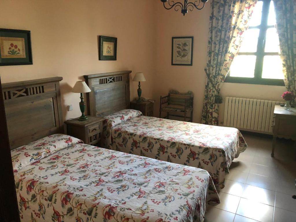 Postel nebo postele na pokoji v ubytování Hostal Las Paneras