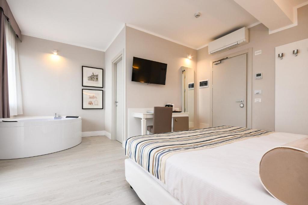 Postel nebo postele na pokoji v ubytování Hotel Oliveto