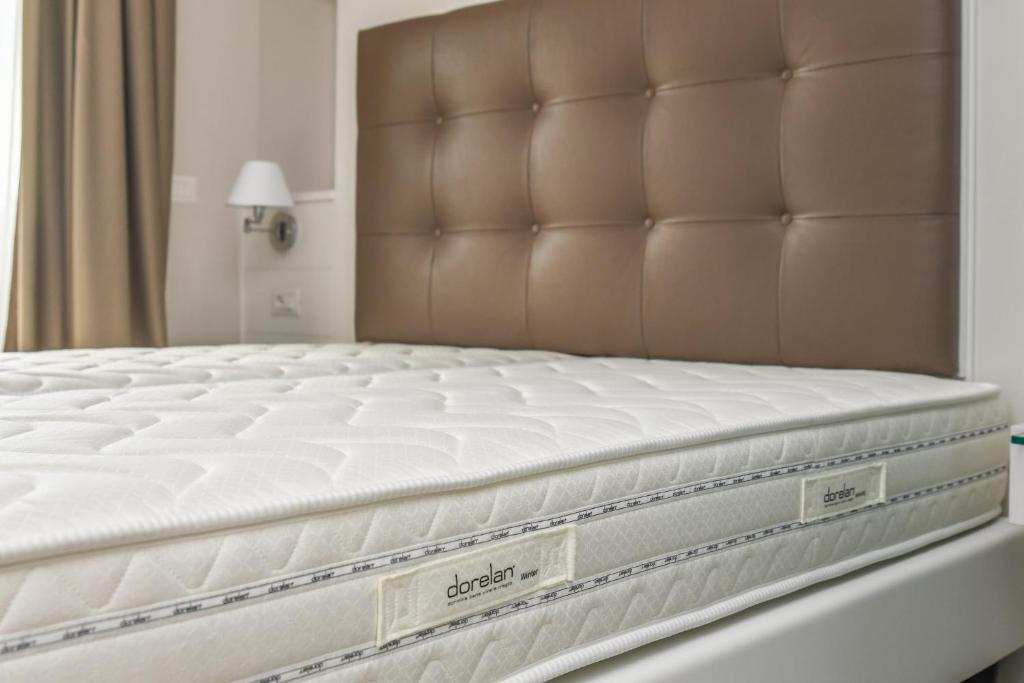Postel nebo postele na pokoji v ubytování Hotel Oliveto