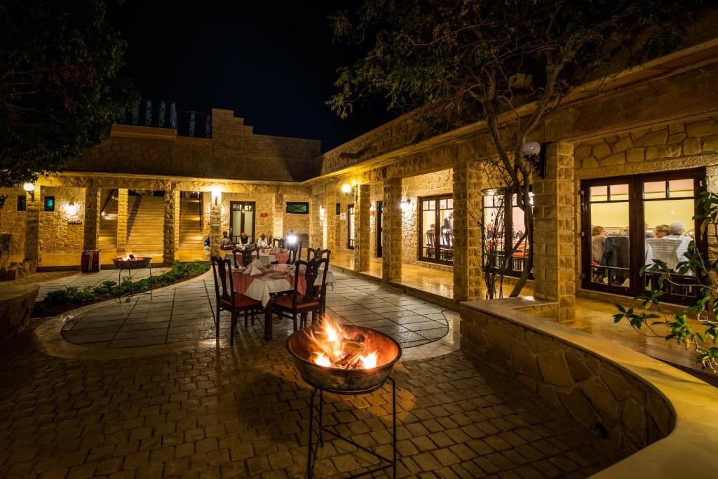 an outdoor patio with a fire pit at night at Hotel Rawalkot Jaisalmer in Jaisalmer
