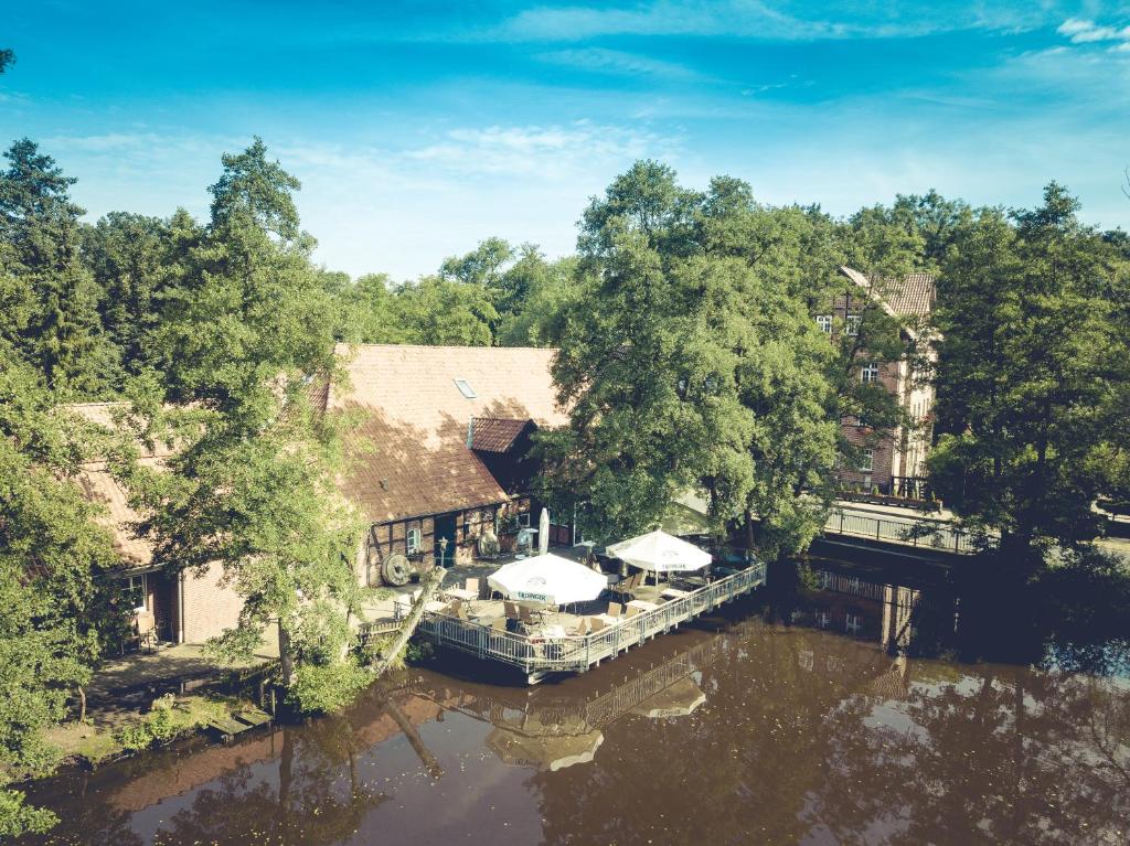 an aerial view of a house on a river at Wassermühle Heiligenthal in Lüneburg