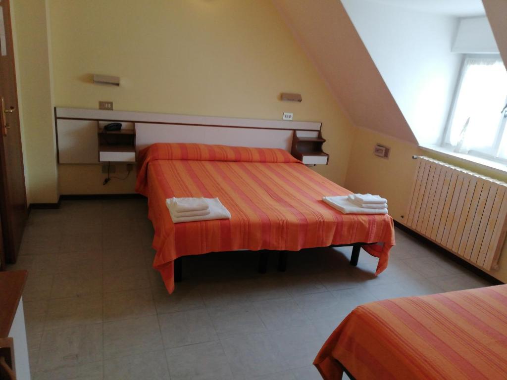 Postel nebo postele na pokoji v ubytování Hotel Ambasciata