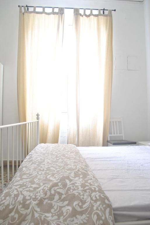 Postel nebo postele na pokoji v ubytování Sunrise Hostel & Rooms